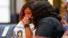 Tamika Palmer, the mother of Breonna Taylor, is comforted by family during a news conference announcing a $12 million civil settlement between the estate of Breonna Taylor and the City of Lousiville, in Louisville, Kentucky, U.S., September 15, 2020. 