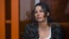 FILE - Ksenia Karelina, also known as Khavana, sits in a glass cage in a court room in Yekaterinburg, Russia, June 20, 2024. 