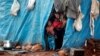 Displaced Syrian children look out from their tents at Kelbit refugee camp, near the Syrian-Turkish border, in Idlib province, Syria, Jan. 17, 2018. 