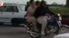 This image taken from video posted on Iranian investigative journalist Masih Alinejad’s Facebook page shows two Iranian women riding a motorcycle. 
