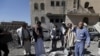 Yemeni Huthis gather around the body of a man killed by air strikes at a detention centre in the capital Sanaa on Dec. 13, 2017.