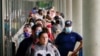 FILE - Job seekers line up outside a Career Center in Frankfort, Kentucky, June 18, 2020. 
