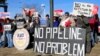 Demonstrators opposing the Keystone XL oil pipeline hold banners in Omaha, Neb., Jan. 13, 2015. Democrats hope to use Senate consideration of the oil pipeline to get Republicans on the record about climate change and resurrect parts of a bipartisan energy