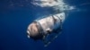 FILE - This undated image courtesy of OceanGate Expeditions shows their Titan submersible beginning a descent. The submersible imploded last year while on its way to the Titanic wreckage. (Handout Photo/OceanGate Expeditions/AFP) 