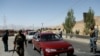 Afghan security forces keep watch at a checkpoint on the Ghazni highway, in Maidan Shar, the capital of Wardak province, Afghanistan, Aug. 12, 2018.