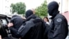 FILE - French special forces escort a suspected jihadist from a residential building in Strasbourg, May 13. 2014.