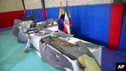 Debris from what Iran's Revolutionary Guard aerospace division describes as the U.S. drone which was shot down on Thursday is displayed in Tehran, Iran, Friday, June 21, 2019.