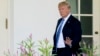 President Donald Trump waves to members of the media as he walks toward the West Wing of the White House in Washington, July 18, 2018.