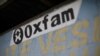 FILE - An Oxfam sign is seen on a kiosk that was used to distribute water in Corail, a camp for displaced people of the earthquake of 2010, on the outskirts of Port-au-Prince, Haiti, Feb. 17, 2018. 