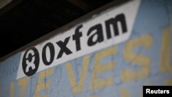FILE - An Oxfam sign is seen on a kiosk that was used to distribute water in Corail, a camp for displaced people of the earthquake of 2010, on the outskirts of Port-au-Prince, Haiti, Feb. 17, 2018. 