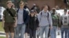 FILE - Students walk across campus at the University of Vermont in Burlington, Vermont.