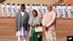 Indian Prime Minister Narendra Modi, right, stands with Nepalese Prime Minister Khadga Prasad Oli and his wife Radhika Shakya during a ceremonial reception for Oli in New Delhi, India, Saturday, April 7, 2018. 