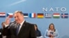 U.S. Secretary of State Mike Pompeo, left, waits for the start of the North Atlantic Council at NATO headquarters in Brussels, April 27, 2018.