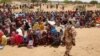Sudanese refugees, who have fled the violence in their country, wait to receive food rations from the World Food Program, near the border between Sudan and Chad, in Koufroun, Chad May 9, 2023. 