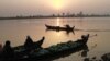 Groceries vendors sit on their boat to cross Irrawaddy river in Myitkyina, February 25, 2012, in Myitkyina, Kachin State, northern Burma.