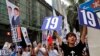 FILE - Supporters of Radical localist group Youngspiration's candidate Baggio Leung shout slogans near a polling station for the legislative council election, Sept. 4, 2016. 
