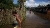 Foto ilustrasi yang menunjukkan warga di negara bagian Bahia, Brazil, saat banjir menerjang wilayah mereka pada 30 Desember 2021. (Foto: AP/Raphael Muller)