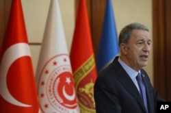 FILE - Turkey's Defense Minister Hulusi Akar speaks to a group of reporters in Ankara, Turkey, May 21, 2019.