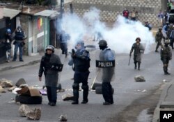 Police fire tear gas at supporters of opposition presidential candidate Salvador Nasralla during clashes in the Policarpo Paz Garcia neighborhood of Tegucigalpa, Honduras, Jan. 20, 2018.