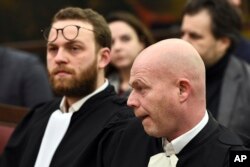 Belgian lawyer Sven Mary, right, and lawyer Romain Delcoigne, left, attend the trial of Salah Abdeslam at the Brussels Justice Palace in Brussels on Monday, Feb. 5, 2018.