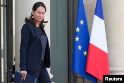 FILE - French Minister for Ecology, Sustainable Development and Energy Segolene Royal leaves following the weekly cabinet meeting at the Elysee Palace in Paris, Oct. 1, 2014.