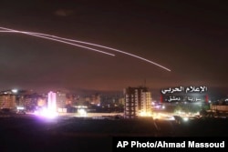 Esta foto, entregada el jueves 10 de mayo de 2018 por los medios militares centrales sirios controlados por el gobierno, muestra que misiles elevándose al cielo cuando misiles israelíes alcanzan una posición de defensa aérea y otras bases militares en Damasco, Siria.