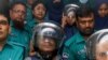 Journalists Shakil Ahmed, fifth from the left, and Farzana Rupa, third from the right, are taken to a court in Dhaka, Bangladesh, on Aug. 22, 2024.