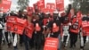 Protestors carrying placards march in the streets of Nairobi, Kenya, June 5, 2018, demanding the government halt a project to build a coal power plant in the city of Lamu. (M. Yusuf/VOA)