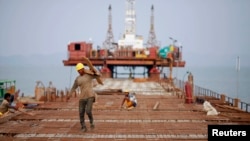 Workers from Indian conglomerate Essar Group construct a new port in Sittwe in Rakhaine state, Burma, May 19, 2012. 