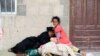 A woman and a girl displaced by the fighting in the Red Sea port city of Hodeida rest at a school where internally displaced people live in Sanaa, Yemen, June 26, 2018.