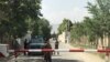 Afghan policemen keep watch near the site of a suicide attack in Kabul, Afghanistan, June 11, 2018. 