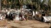 Muslim refugees stand near their tents in Awetawgyi refugee camp in Sittwe, Rakhine State, western Burma, January 8, 2013.
