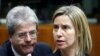 European Union foreign policy chief Federica Mogherini and Italian Foreign Minister Paolo Gentiloni (L) attend a meeting of European Union foreign and defence ministers at the EU Council in Brussels, Belgium, May 18, 2015. 