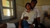 An injured Rakhine Buddhist man leans on his father at a hospital in Sittwe, the capital of Myanmar's western Rakhine state after they were recently injured at the four different districts outside Sittwe, October 26, 2012.