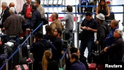 Passengers with their baggage move through the Tom Bradley International Terminal at Los Angeles International Airport (LAX), California, April 24, 2013. 