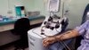A recovered COVID-19 patient donates blood at the Arnulfo Arias Madrid Hospital, in Panama City, Wednesday, May 13, 2020. The blood product donated from recovered COVID-19 patients, known as convalescent plasma, may have antibodies that can help those cri