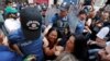 FILE - Demonstrators scuffle with the police as they prevent Saturday Mothers' 700th gathering, that meets every week, demanding to know the fate of their missing relatives, claimed to be last seen in the hands of security forces, in central Istanbul, August 25, 2018. 