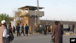 FILE - Pakistan security officials surround a central jail in Bannu, 170 kilometers south of Peshawar. 