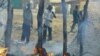 Men look at a market destroyed by a Sudanese air force air strike in Rubkona, near Bentiu, South Sudan, April 23, 2012.
