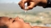 An Afghan health worker vaccinates a child as part of a campaign to eliminate polio, on the outskirts of Kabul, Afghanistan, April 18, 2017.