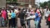 Men carry a body in the Nyakabiga neighborhood of Bujumbura, Burundi, where a number of people were found shot dead a day after the government said an unidentified group had carried out attacks on three military installations, Dec. 12, 2015.