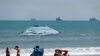 Beach goers enjoy the sun, April 4, 2020, in Cape Canaveral, Fla. Some of the state’s Atlantic Ocean beaches have reopened. 