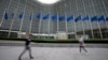FILE - European Union flags wave in the wind as pedestrians walk by EU headquarters in Brussels, on Sept. 20, 2023. The European Union said Dec. 18, 2023, that it has imposed fresh sanctions on Russia over its war against Ukraine, targeting the lucrative diamond industry.