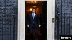 FILE - Britain's Foreign Secretary Jeremy Hunt leaves 10 Downing Street, London, Britain, Nov. 13, 2018.