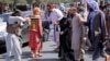 A member of the Taliban points his gun at protesters in Kabul, Afghanistan Sept. 7, 2021.