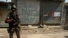 FILE - A Pakistani soldier stands in front of closed shops during a military operation against Taliban militants in the town of Miranshah in North Waziristan, July 9, 2014. 