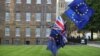 An anti-Brexit protester carries flags opposite the Houses of Parliament in London, Britain, May 10, 2018. 