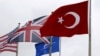 FILE - A Turkish flag, right, flies among others flags of NATO members at the Alliance headquarters in Brussels, Belgium, July 28, 2015. 