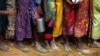 FILE _ Bare feet of Rohingya refugee children are pictured as they stand in a queue while waiting to receive food outside the distribution center in Palongkhali makeshift refugee camp in Cox's Bazar, Bangladesh, Nov. 7, 2017. 