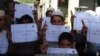 FILE - IS social media distributed photos of children holding placards in Islamic State territories offering "congratulations" on American deaths, apparently in reference to a Florida shooting, on June 12, 2016. In May 2019, IS is increasing attacks and social media posts.